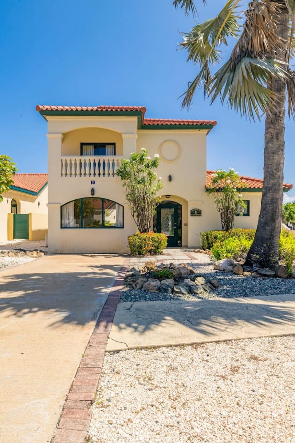 A welcoming main entrance with stylish doors, sleek lighting, and lush greenery, creating an inviting first impression that leads into a beautiful home