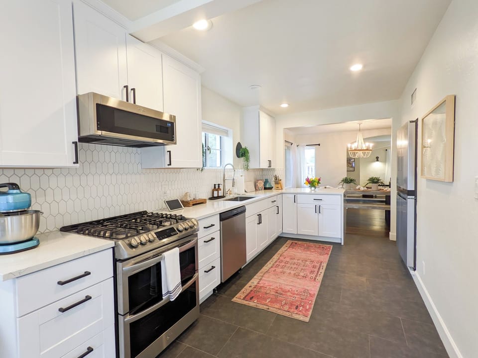 Convenient kitchen, stocked with utensils, dishes, pots and pans that you will use to prepare meals!
