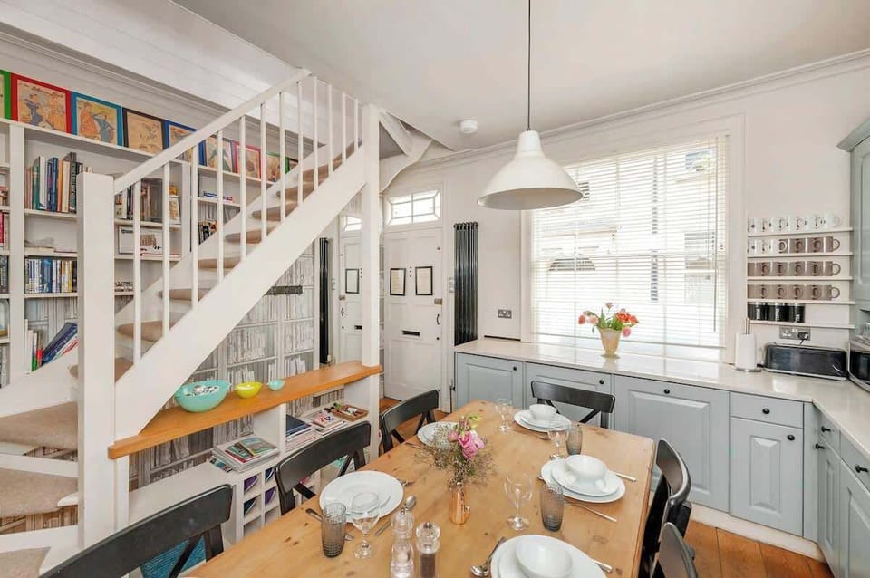 Dining Table with staircase and bookshelf
