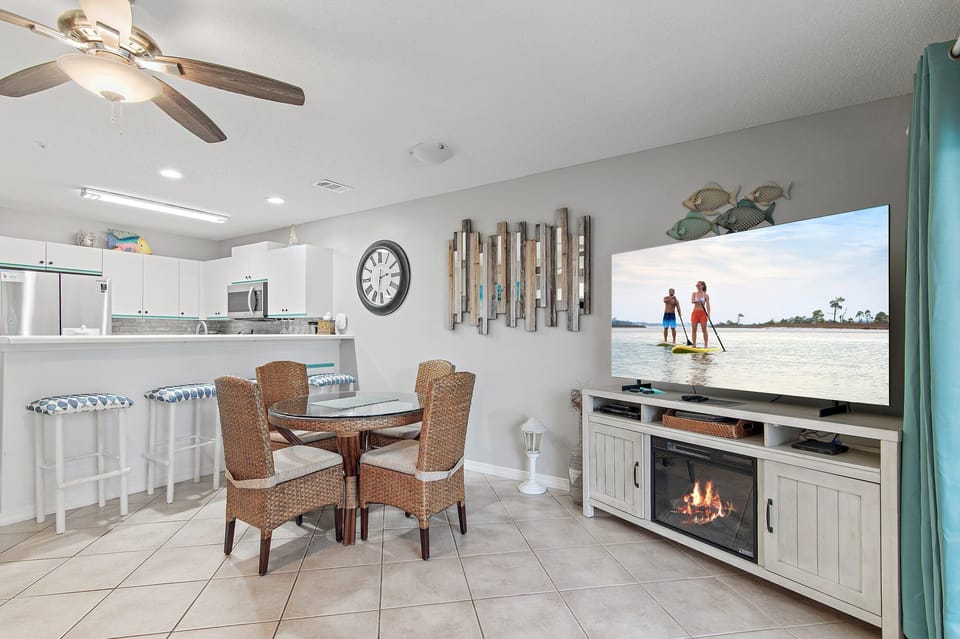 Cozy up by the fireplace beneath a smart TV.