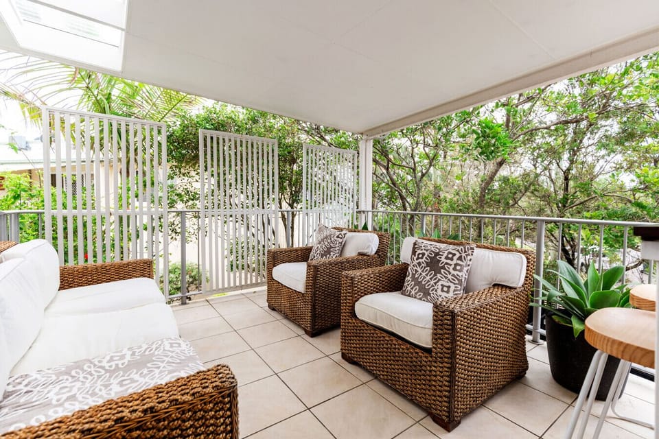 Balcony area with outdoor seating and breakfast bar