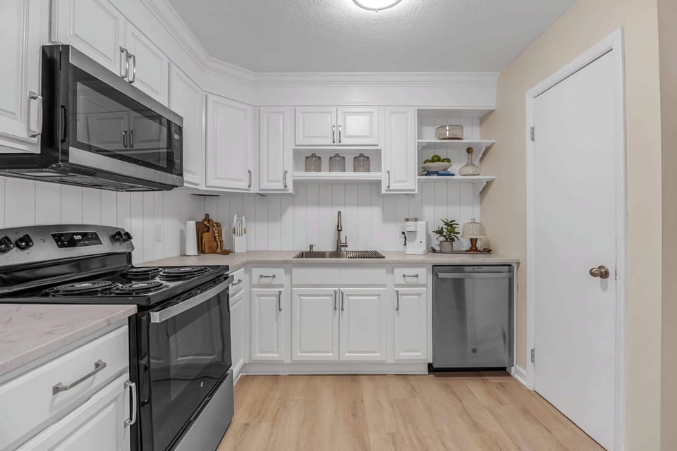 Modern kitchen with stainless steel appliances and white cabinetry