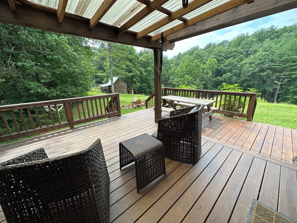 Back deck is great gathering spot overlooking the garden, barn and orchard