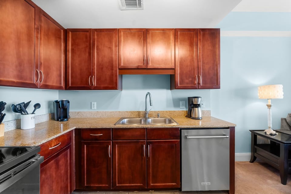 Modern kitchen with stainless steel appliances and rich wood cabinetry