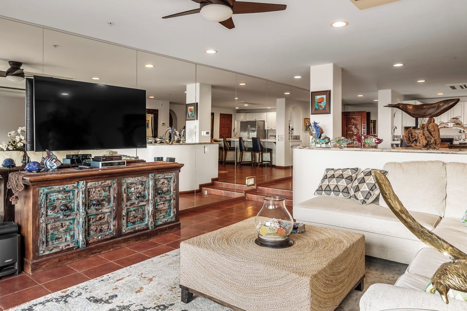 Relax in your spacious living area with sleek modern furnishings, entertainment center, and stylish décor that creates the perfect atmosphere for unwinding.