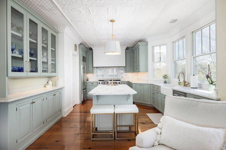 Pass into the kitchen, featuring high-end appliances and large windows