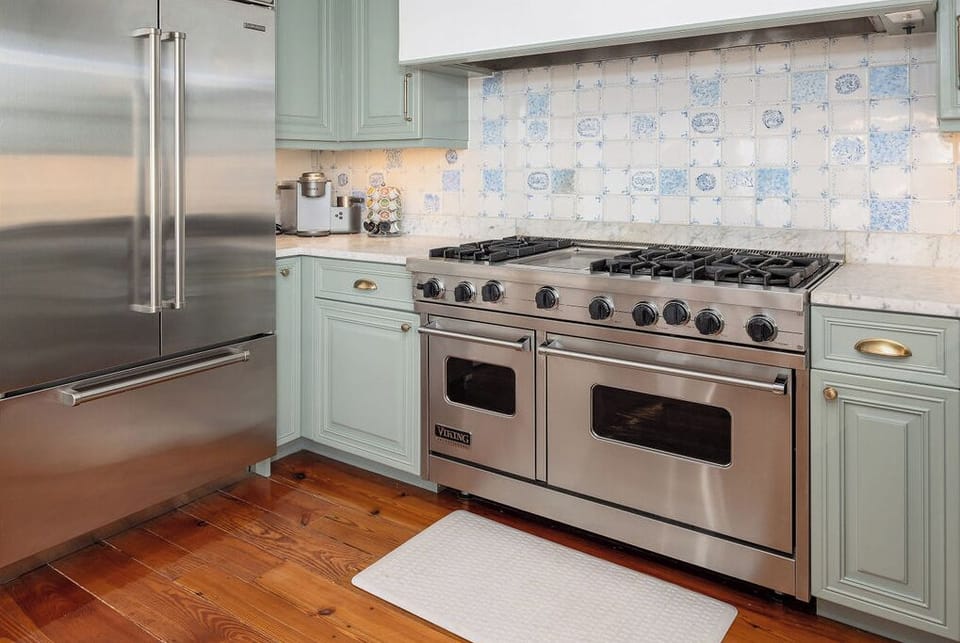 Your kitchen includes a professional gas range and hand-painted tile backsplash