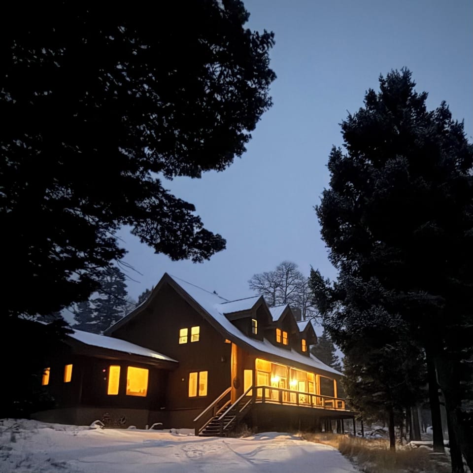The warm glow of a winter cabin in the woods, invites you to come on in.