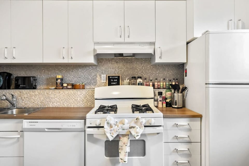 Full kitchen featuring gas stove, dishwasher, and ample counter space