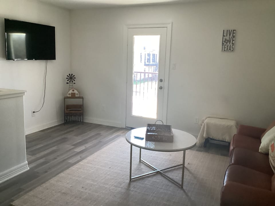 Ample living room , with door going to outside balcony