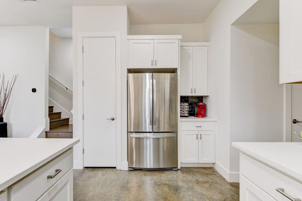 A chef’s dream! This fully stocked kitchen features modern stainless steel appliances, a Keurig coffee station, and all the essentials to whip up a great meal.