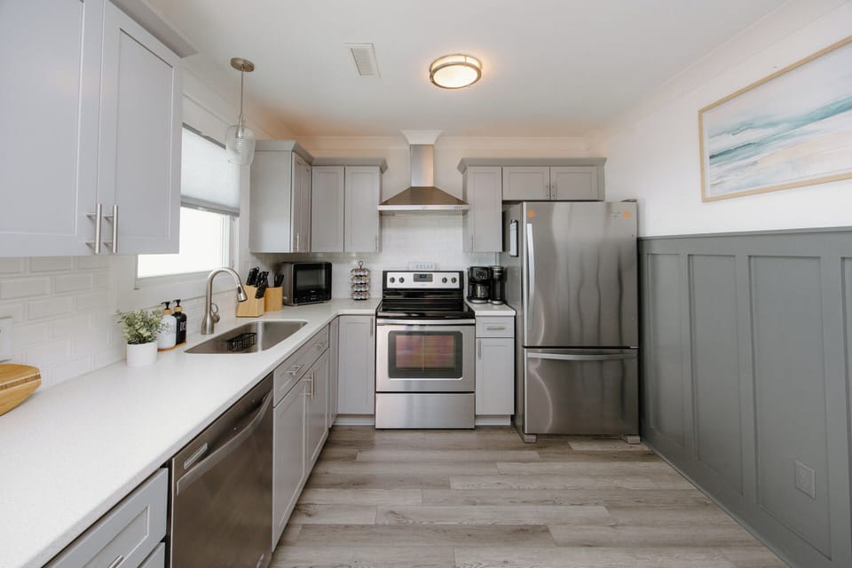 Fully equipped kitchen with modern appliances, cooking essentials, spices