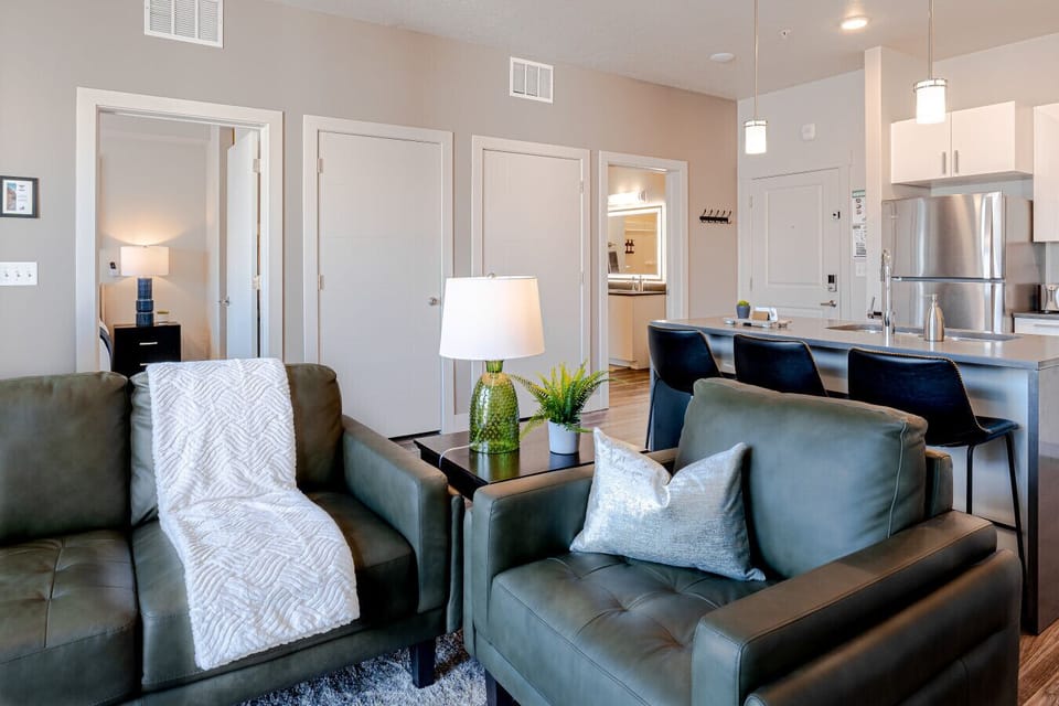 Light filled and spacious living room with luxury leather sofa, 65` TV.