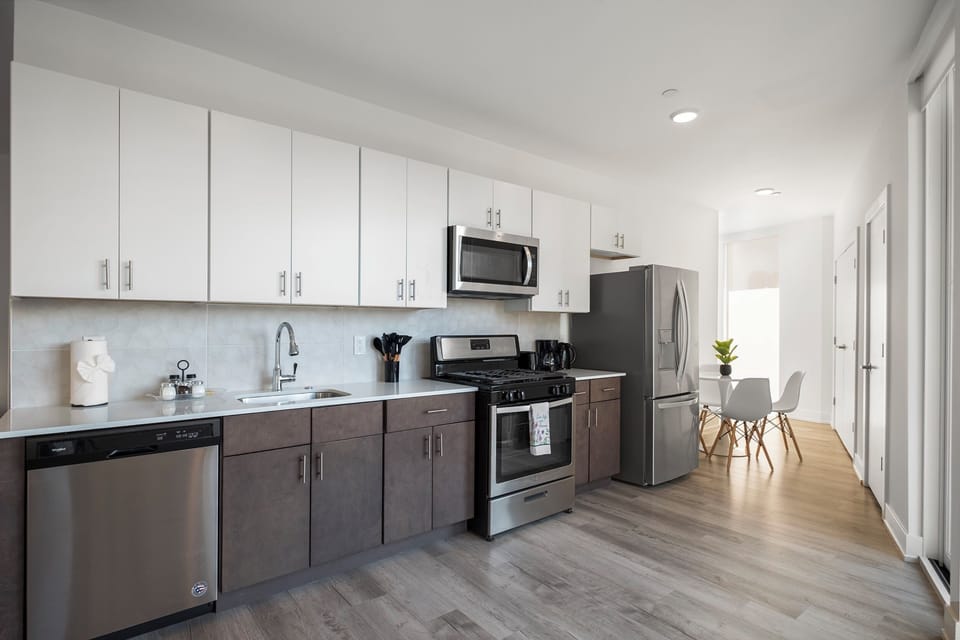 Kitchen featuring wood cabinets, gas range, and complete cookware ready for cooking.