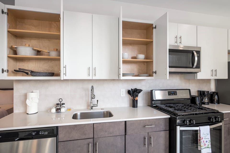 Kitchen detail showing modern white cabinetry and functional cooking space.