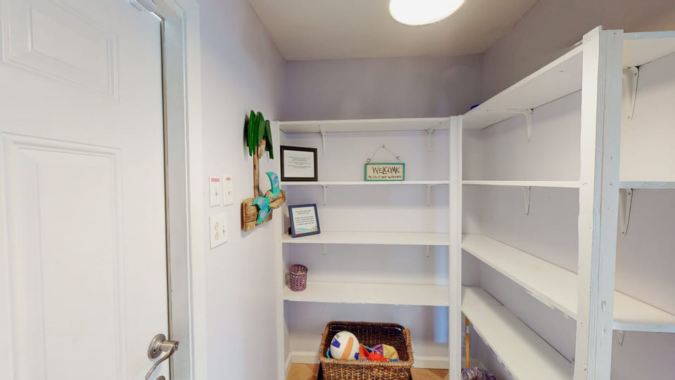 The mud room is the perfect are to remove footwear and outerwear to avoid tracking water and debris throughout the house. The shelves provide plenty of space for storing everyone's shoes and beach gear.