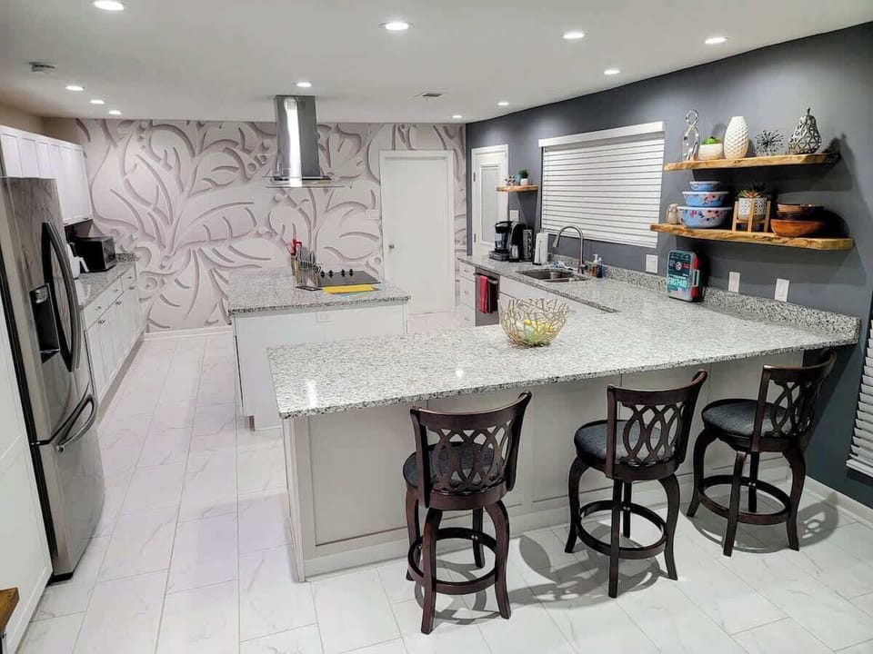 Oversized light kitchen with ample room for preparing meals, entertaining, or family gatherings.