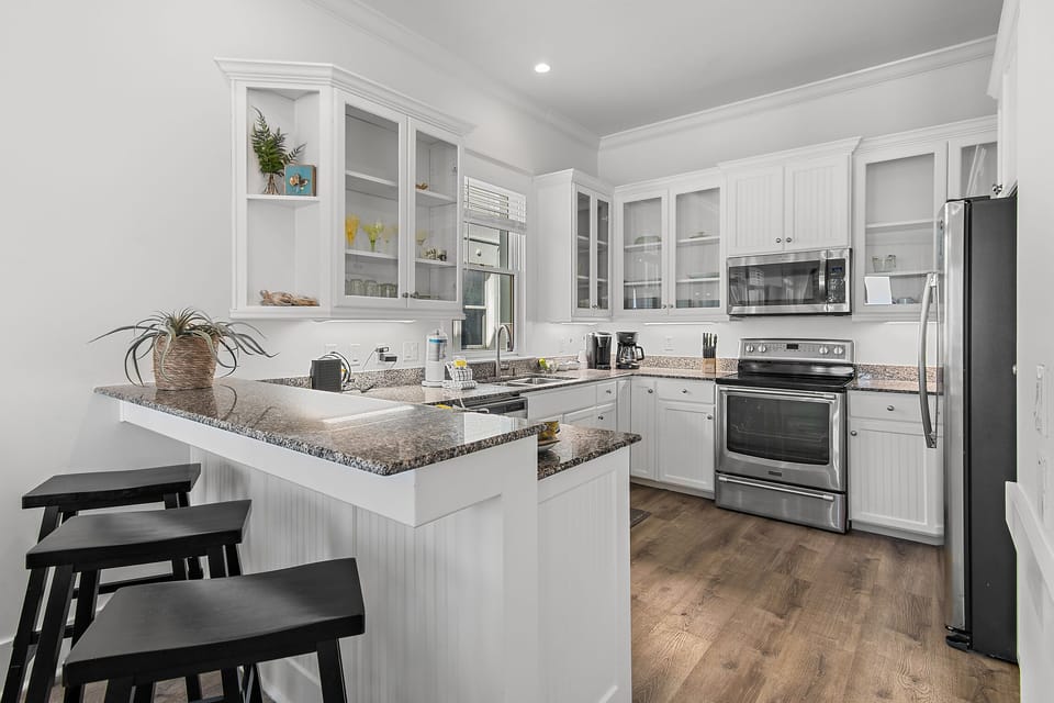 Remodeled Kitchen with granite countertops, stainless appliances - cook delicious meals and dine while overlooking the Gulf of Mexico!