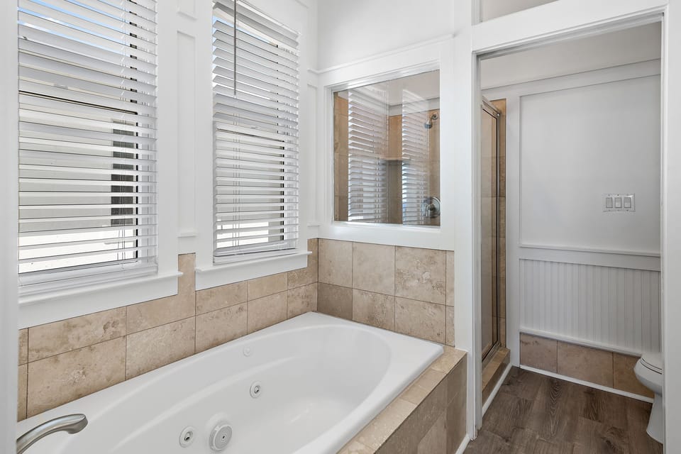 Spacious Master Bedroom (3rd Floor) with King Bed, 55" Smart TV, Gulf Views, Private Balcony, Bathroom with dual vanity, soaker tub & walk-in shower