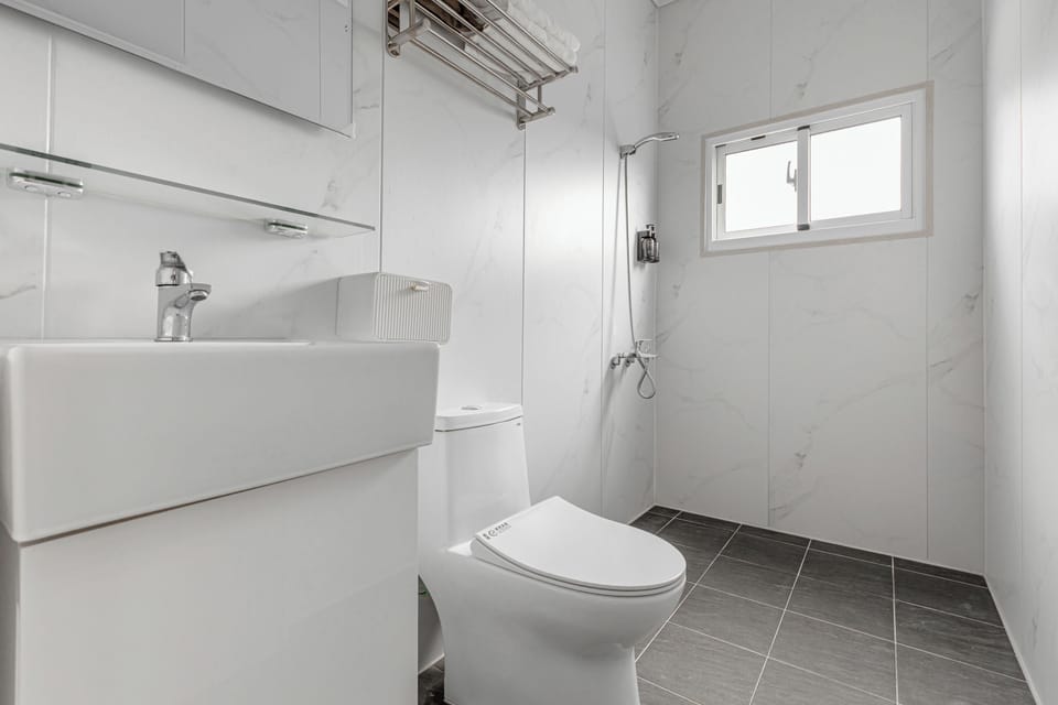 Standard Quadruple Room | Bathroom | Shower, hair dryer, slippers, towels