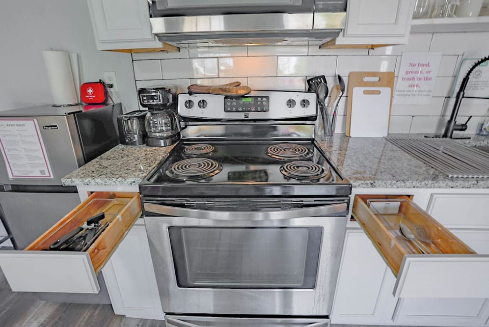 Prepare meals with ease in a clean, modern space featuring essential appliances and cookware