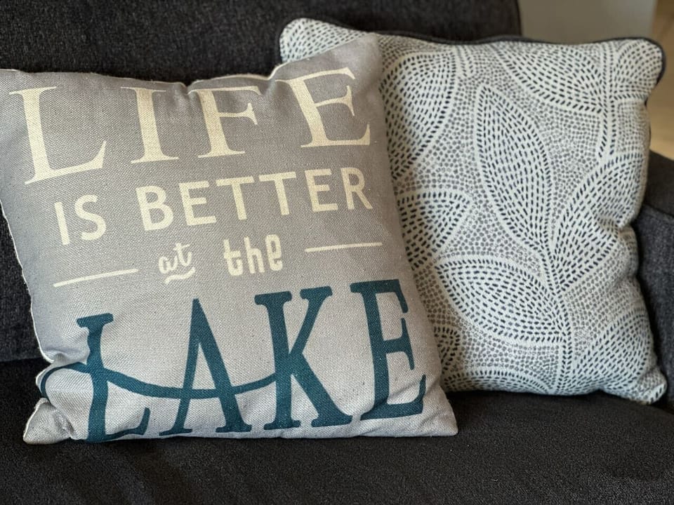 Thoughtful touches like `Life is Better at the Lake` and `Lovin’ Life at the Lake` pillows bring the perfect vacation vibe.