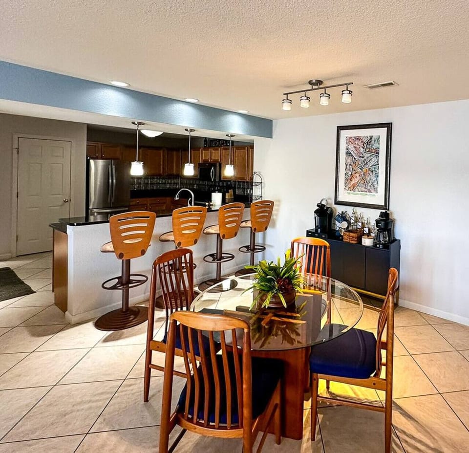 The kitchen and dining areas are bright and spacious, with stylish pendant lighting, a fully equipped kitchen, and a beautifully set dining table for a comfortable stay.