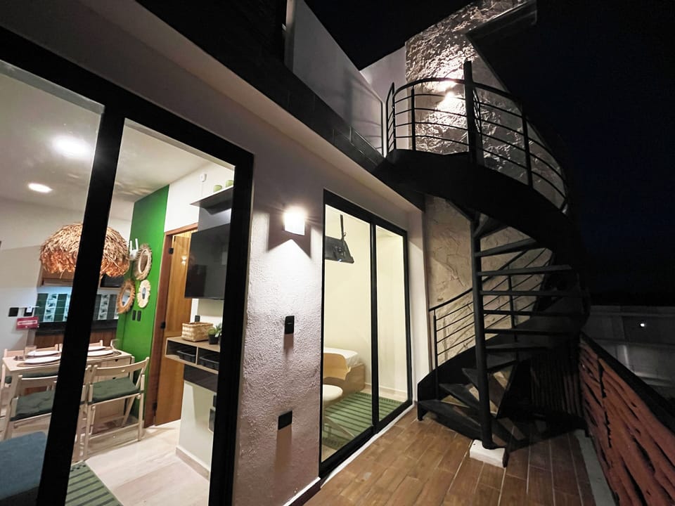 From your balcony, enjoy Tulum's glow. Upstairs, a private rooftop spa awaits.