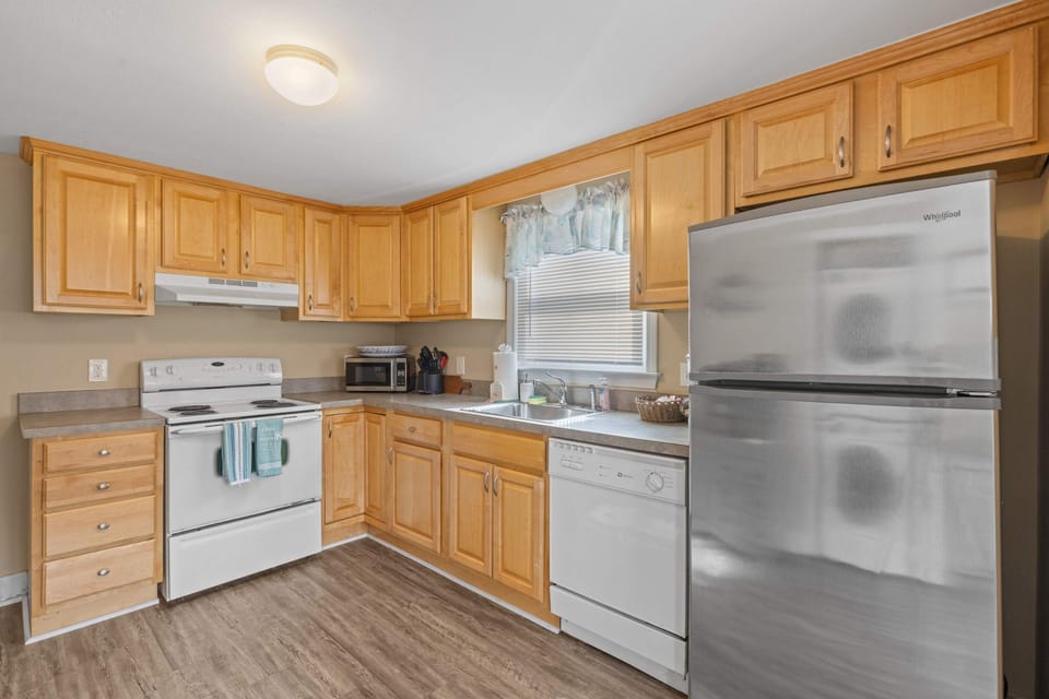 Cook Like a Local! This bright and spacious kitchen has everything you need—from a full stove to a microwave and dishwasher—perfect for preparing fresh seafood feasts or easy family meals.