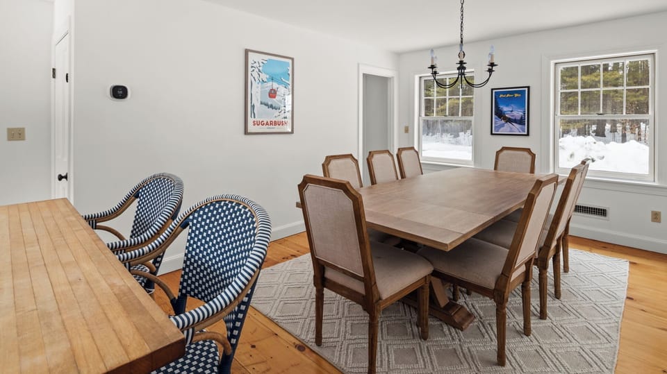 - Dining area with rustic table and chandelier   - Seating for large groups in bright cozy space   - Perfect for holiday meals and celebrations