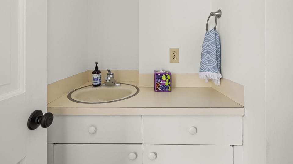 - Half bathroom with sink and essentials for guest convenience   - Simple clean design offers easy comfort during your stay   - Practical guest-friendly amenity with bright fresh style