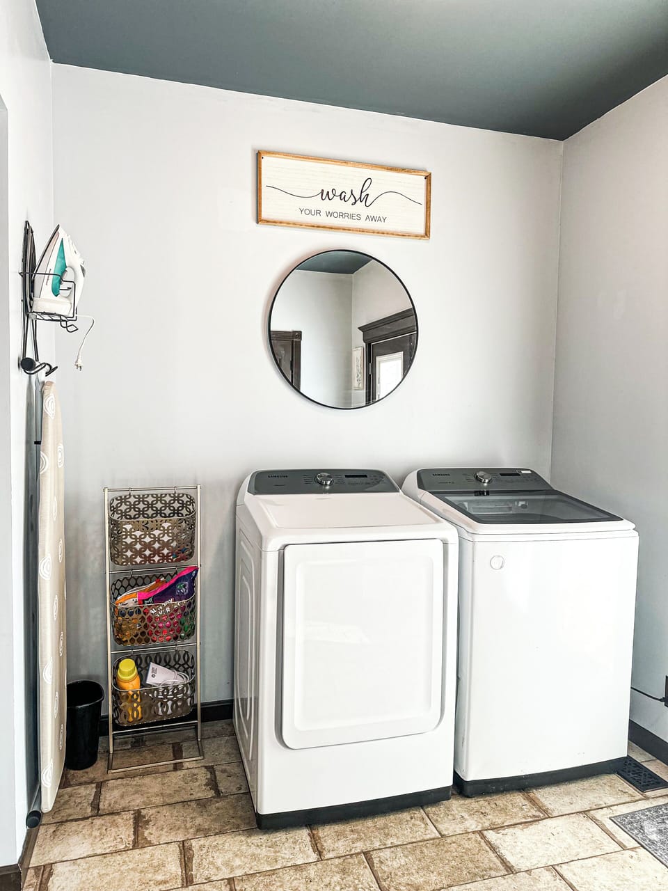 Laundry Room Convenience – A well-organized laundry space with modern appliances, an ironing station, and a touch of decor to brighten up the chore.
