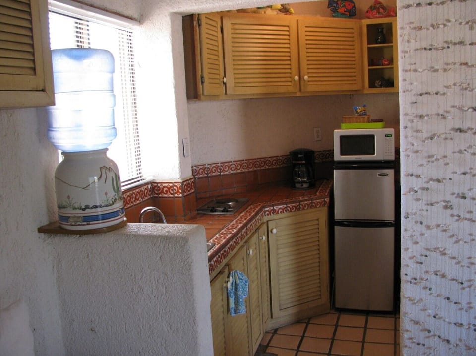 Condo has stove top, fridge, air fryer, various other kitchen gadgets.