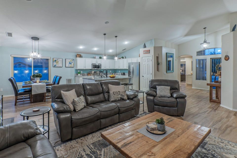 Great room includes a spacious sitting area, dining area and modern kitchen.