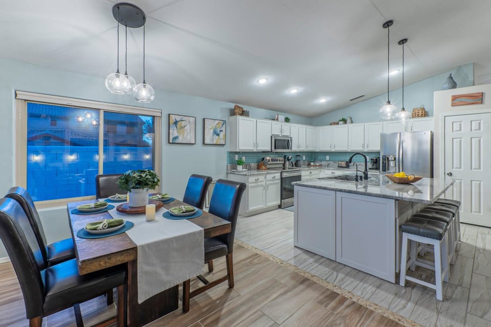 Well stocked kitchen has both table and island seating for meals.