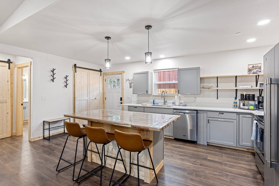 The kitchen island includes three comfortable breakfast chairs.