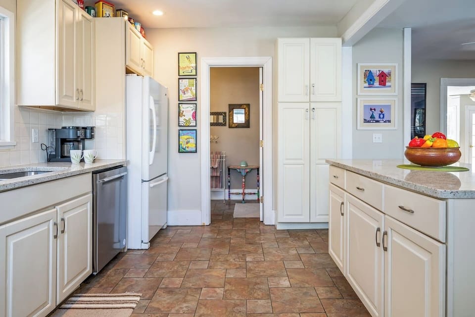 This airy kitchen features plenty of storage, modern appliances, and a seamless flow into the dining area for easy entertaining.