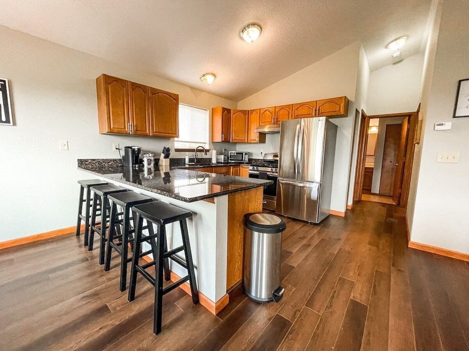 A stocked kitchen with a fridge, microwave, electric range and oven. We also provide the basics such as salt, pepper, cooking oil.