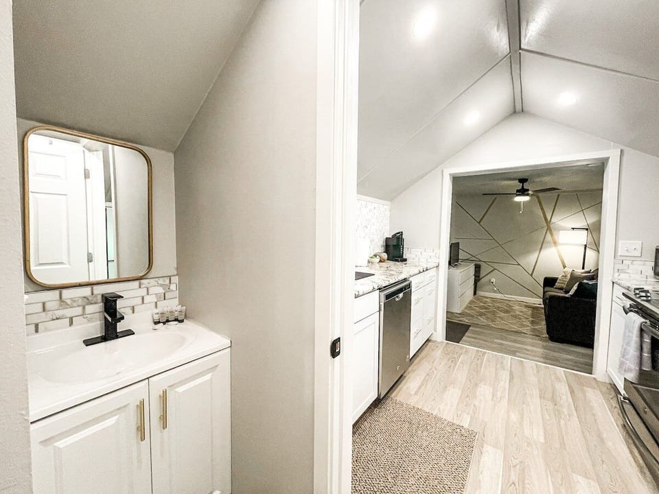 The bathroom is off the kitchen right before the bedroom