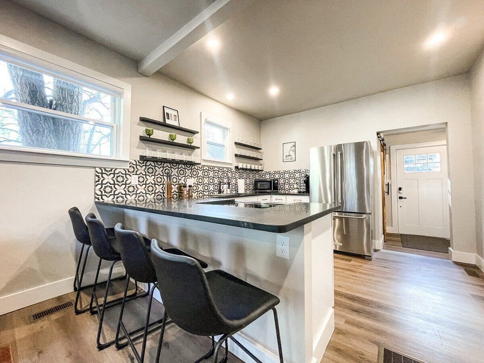Fully equipped with updated stainless steel appliances, ample cookware, and bar seating for four