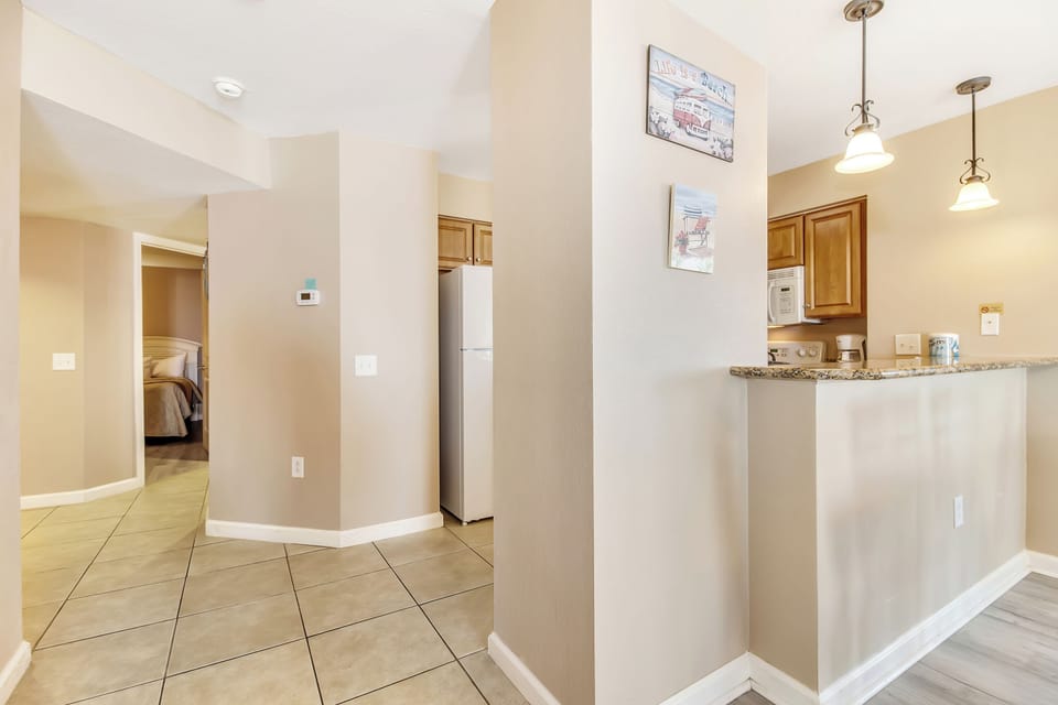 Your spacious kitchen awaits with granite counters, modern appliances, and warm lighting for memorable meal preparations.
