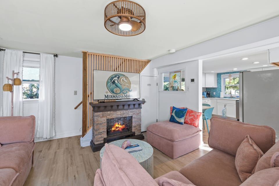 Cozy living room with a fireplace, TV, and plenty of space to unwind together. 