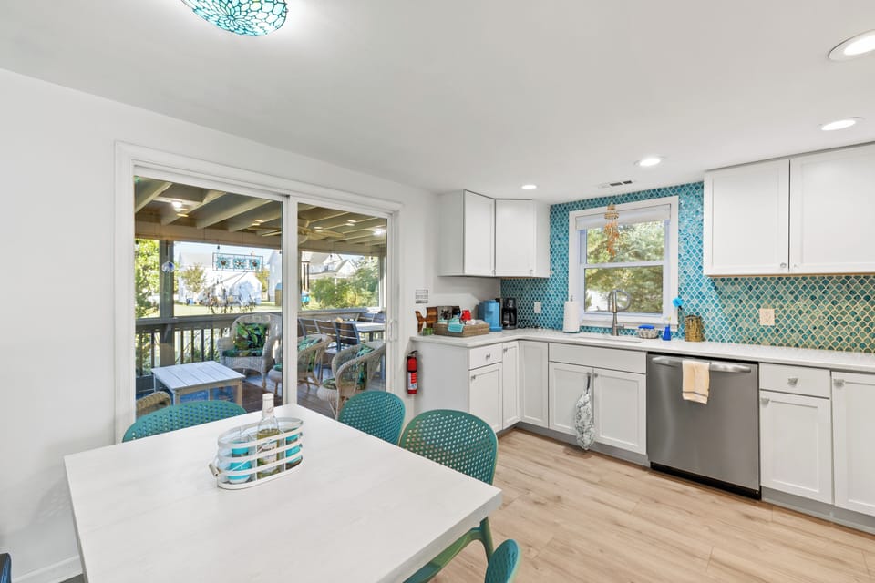 Bright eat-in kitchen, easy access to screened porch for indoor/outdoor dining.