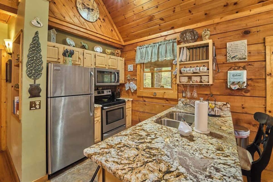 The fully equipped kitchen features elegant granite countertops and modern stainless steel appliances, combining style and functionality for a seamless cooking experience.