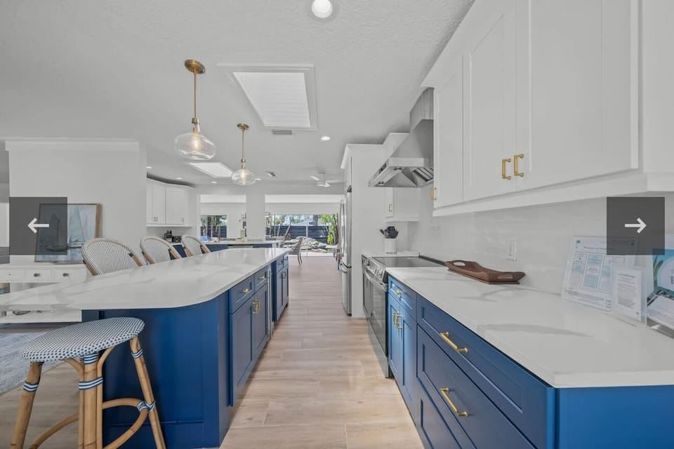 Open-concept kitchen with a statement island and storage underneath.