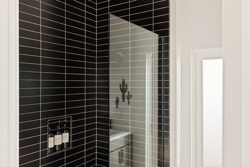 Bathroom 1, black tile shower