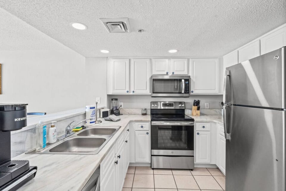 The kitchen is fully stocked with fresh new top of the line stainless steel appliances and