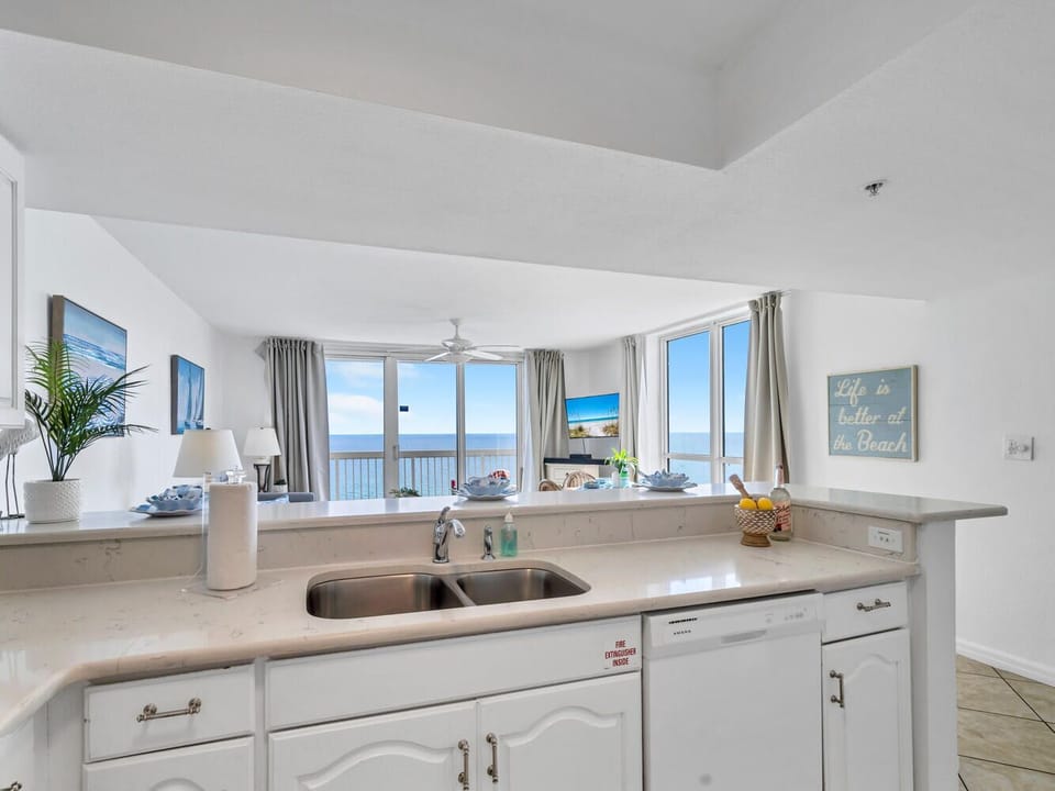 Your bright kitchen overlooks endless water views while you prepare meals with coastal breezes flowing through the windows.