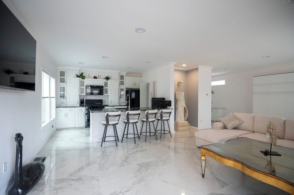 View from front door entrance, kitchen, barstool countertop seating. 