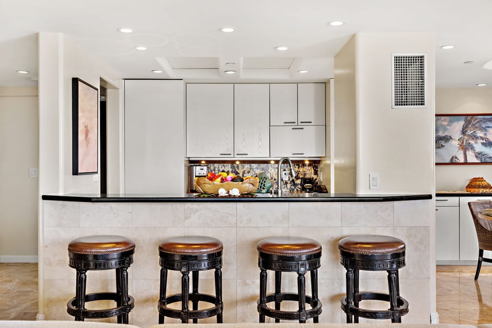 Your gourmet kitchen awaits with rich wood cabinetry, granite counters, and stainless-steel appliances. Perfect for preparing memorable meals together.